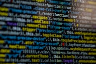 An extreme close-up of colorful programming code on a computer screen, showcasing development and software debugging.